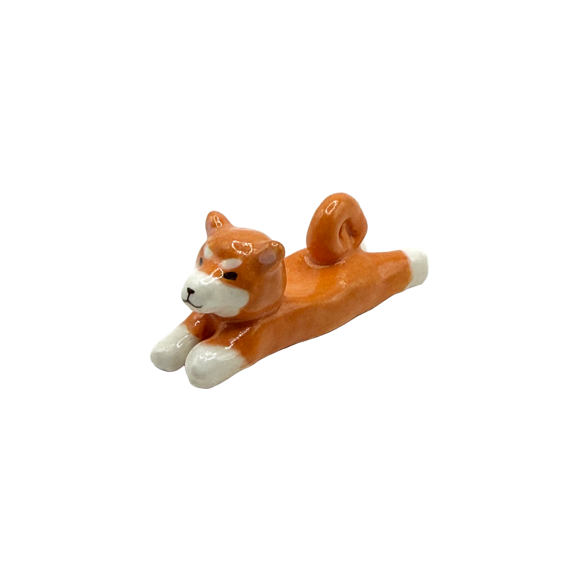 Ceramic shiba inu dog figurine on a white background